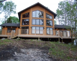 Exterior newly built house and deck with large front windows