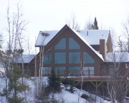 Exterior newly built cabin with deck and large front windows